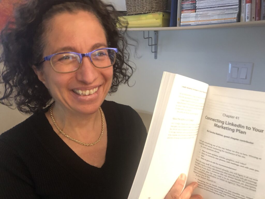 Sandra Bekhor holds LinkedIn® Marketing Techniques book open to the chapter she wrote: Connecting LinkedIn to Your Marketing Plan